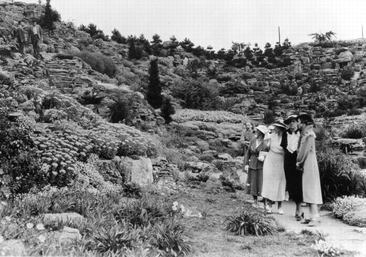 group of four women standing in the newly constructed rock garden.