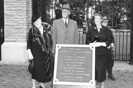 Hendrie Family Standing Behind Plaque
