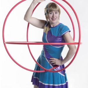 Bex in Motion bex holding two hoola hoops in a sphere around her body