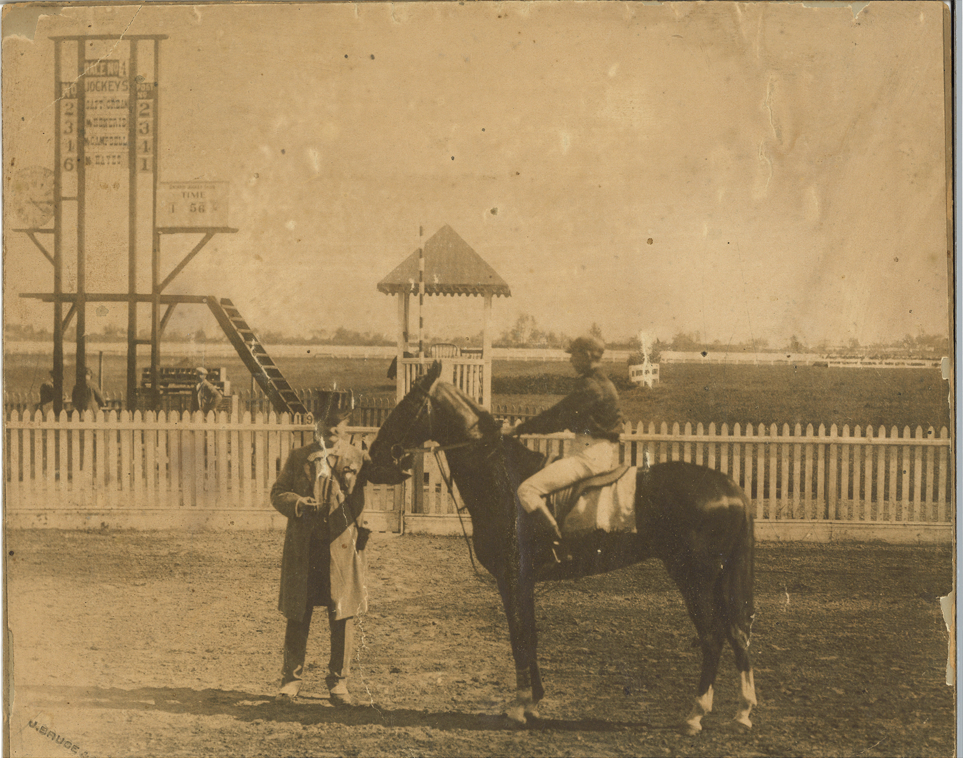 archival photo of jockey on martimas the race horse at a track with owner