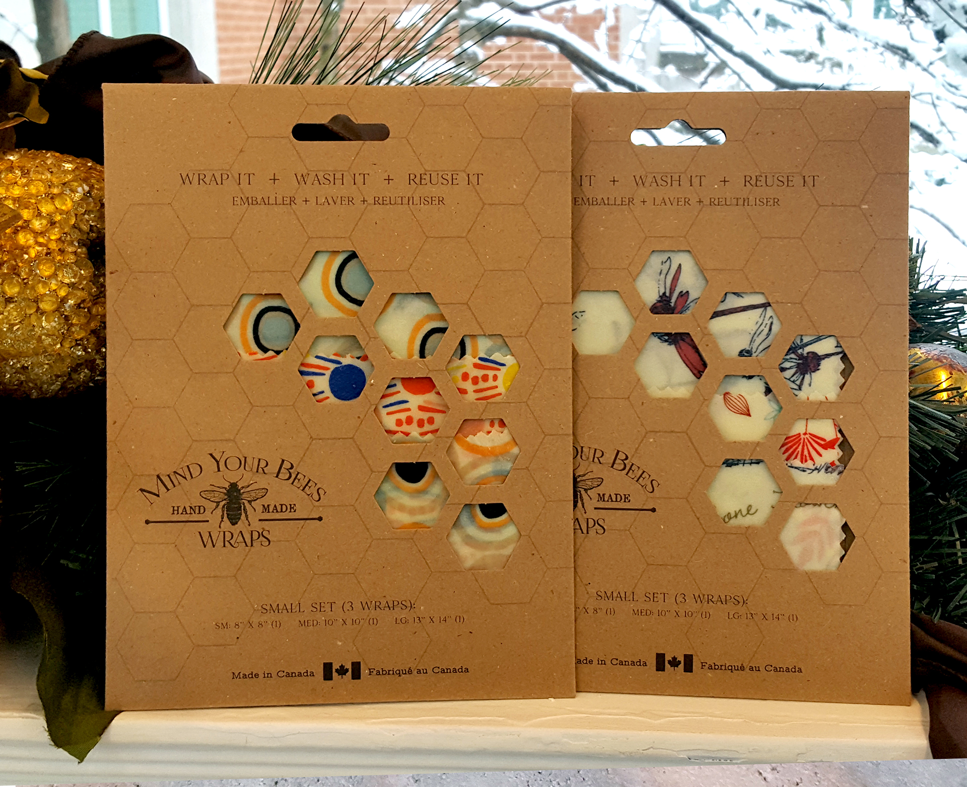 Two packages containing colourful beeswax food wraps by Mind Your Bees