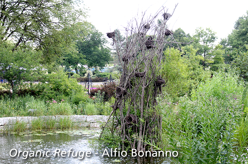 Organic Refuge - sculpture made of sticks in pond