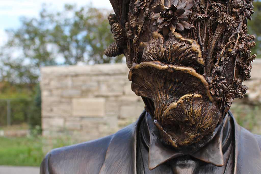 Flora Hominis Sculpture - bronze figure in suit with face made from plants