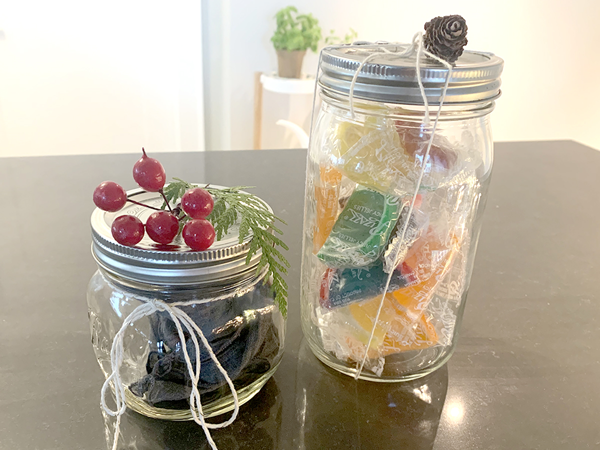 jars filled with treats and decorated with string and nature-themed decorations
