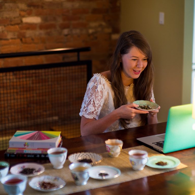 Katie Cyr hosting virtual tea talk with laptop