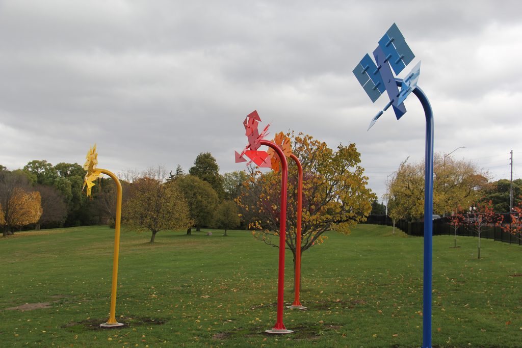 Four pinwheel-like kinetic sculptures installed in Hendrie Park