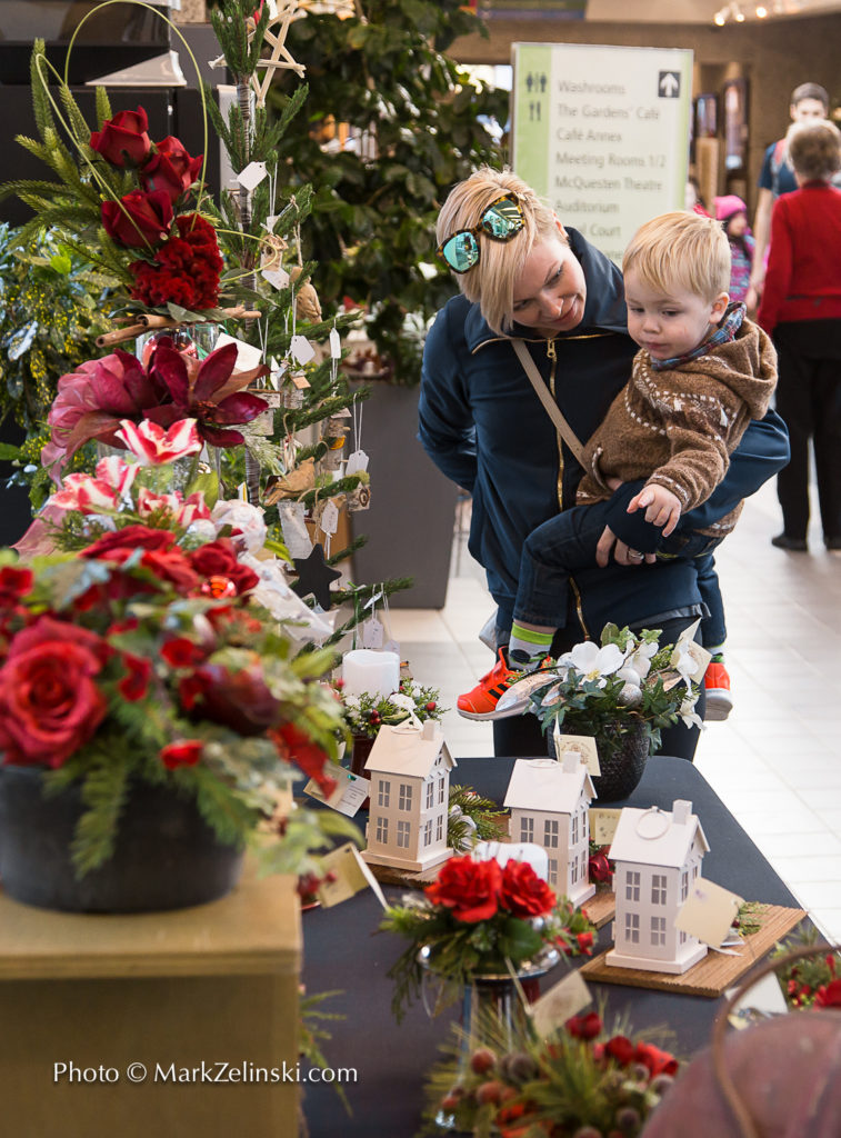 Mother With Child Looking At Christmas Decor Credit Markzelnski.com