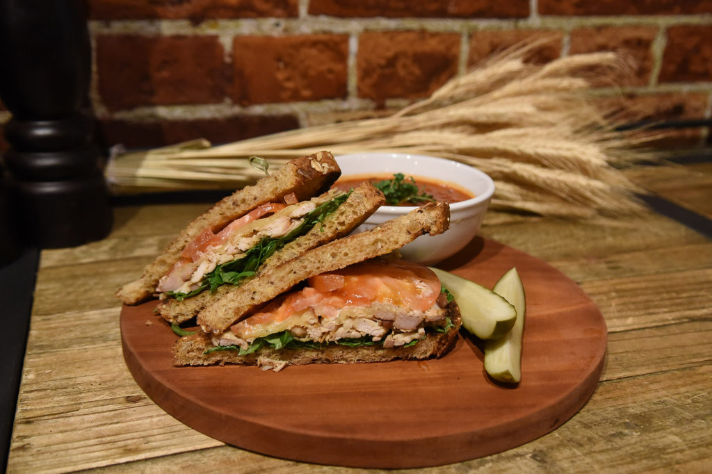 Turkey Club Sandwich On Wooden Platter