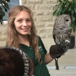 Teen girl holding owl